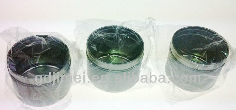 small round tin box with clear widow