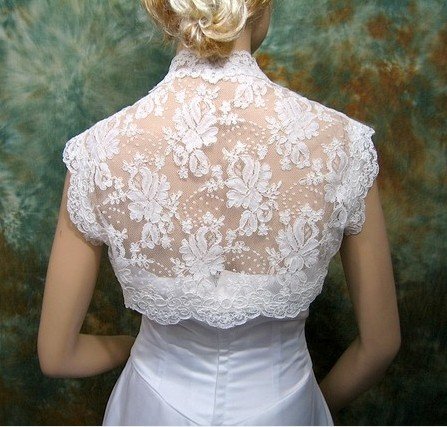 This is an ivory sleeveless bridal shrug bolero jacket made of alencon lace
