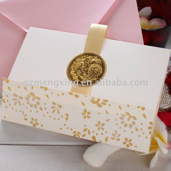 White Elegant invitation card with a golden badge tied with a nice ribbon 